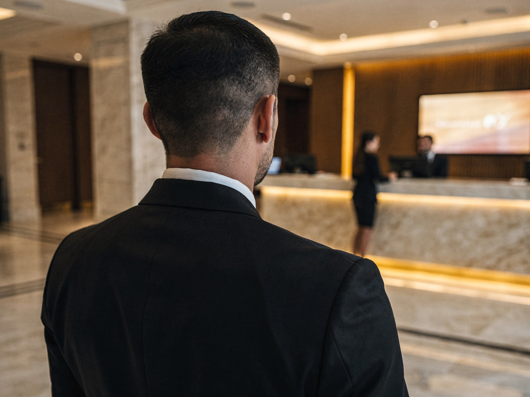 Discreet bodyguard standing watch in a hotel reception